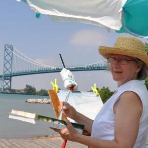 Elizabeth painting on the Detroit River, the famous US/Canadian Ambassador Bridge in the Background